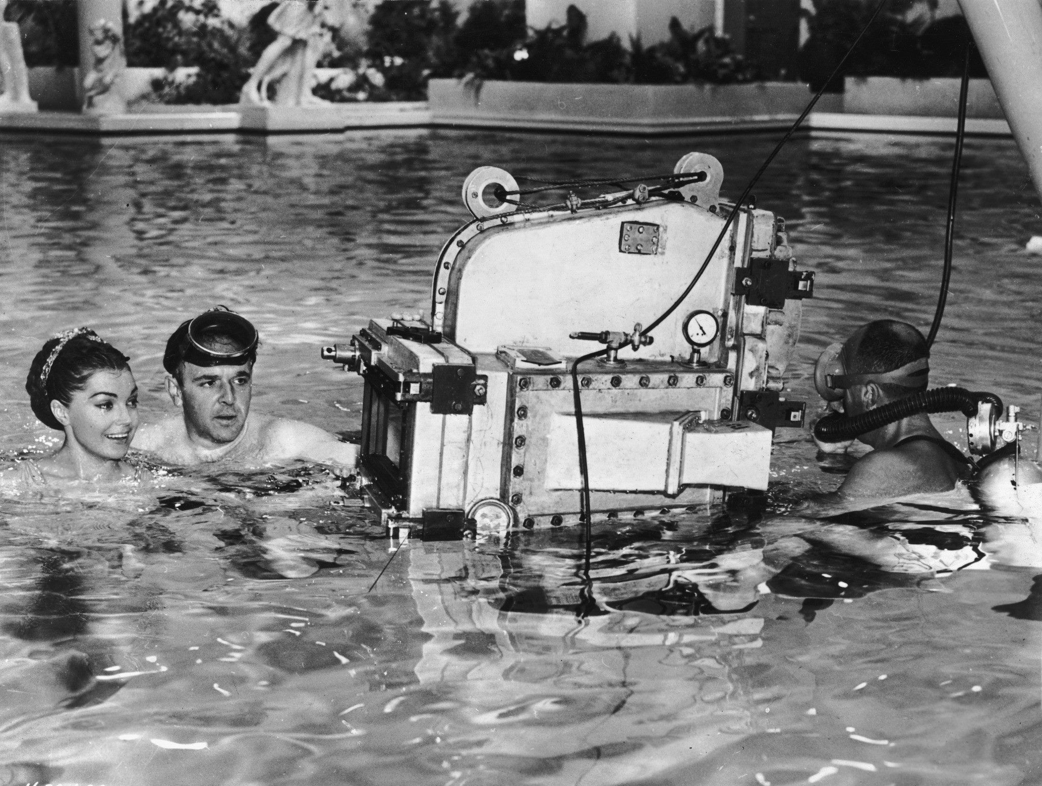 1955: George Sidney, left, while directing swimmer and actress Esther Williams on the set of his film "Jupiter's Darling." The cameraman is wearing scuba gear. [Photo: Hulton Archive]