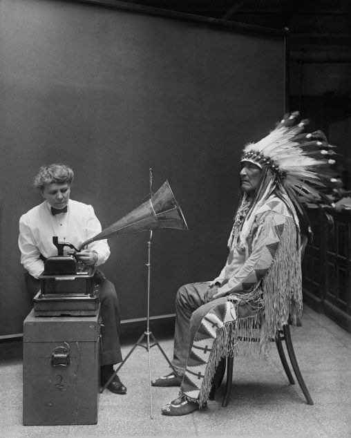 Ethnomusicologist Frances Densmore at the Smithsonian Institution during a recording session with Blackfoot leader Mountain Chief for the Bureau of American Ethnology, 1916.