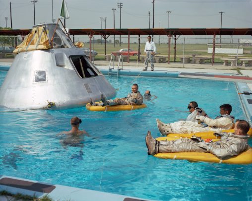 Apollo 1 Crew Members (June 1966). Prime crew members announced by NASA for the first manned Apollo 1 flight practice water egress procedures in a swimming pool at Ellington Air Force Base in Houston. Astronaut Edward H. White II rides life raft in the foreground. Astronaut Roger B. Chaffee sits in hatch of the boilerplate model of the spacecraft. Astronaut Virgil I. Grissom, third member of the crew, waits inside the spacecraft. The Apollo 1 never made it to space, though, as the crew was lost in a fire during a ground simulation. (NASA)