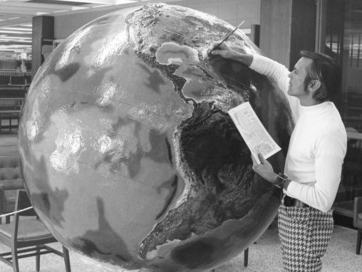 Professor Dan Stillwell of the then Department of Geography and Community Planning paints the coast of Florida on a model of the Earth in December 1975.