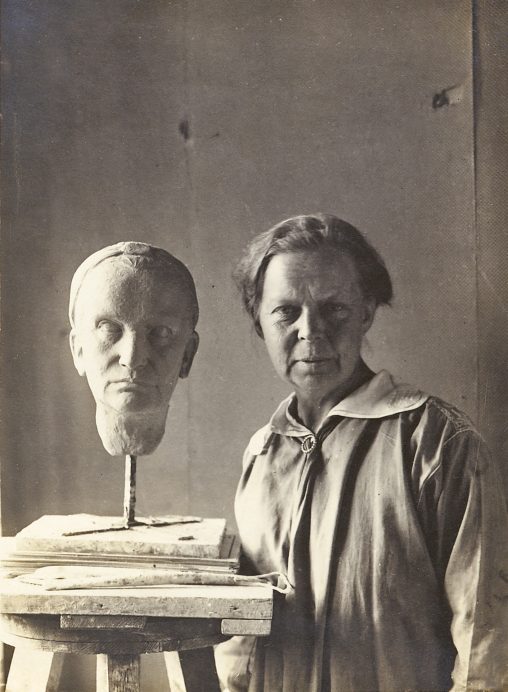Mary Warburg (born Hertz) in the studio next to her bust of Lili du Bois-Reymond, 1923
