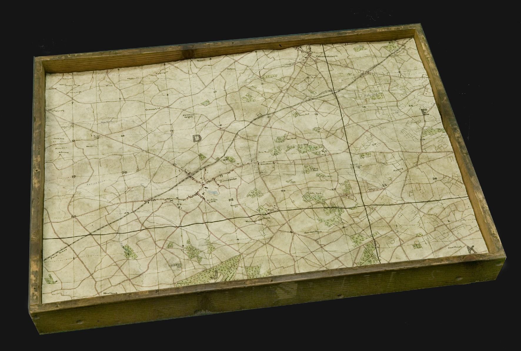 Relief map of Zonnebeke area, Belgium, 1919. These maps were made in London by the Australian War Records Section, by men who were still in England, waiting to be repatriated home, after WWI. The reasons behind the creation of these maps are unclear. Maps like this one were made with a final coat of papier-mâché. Once the map was dried, details were transferred from the relevant 1:10,000 or 1:20,000 trench map by hand. All those details, including map grid squares were included on the items as they were maps in the truest sense of the word, not just models of the landscape.