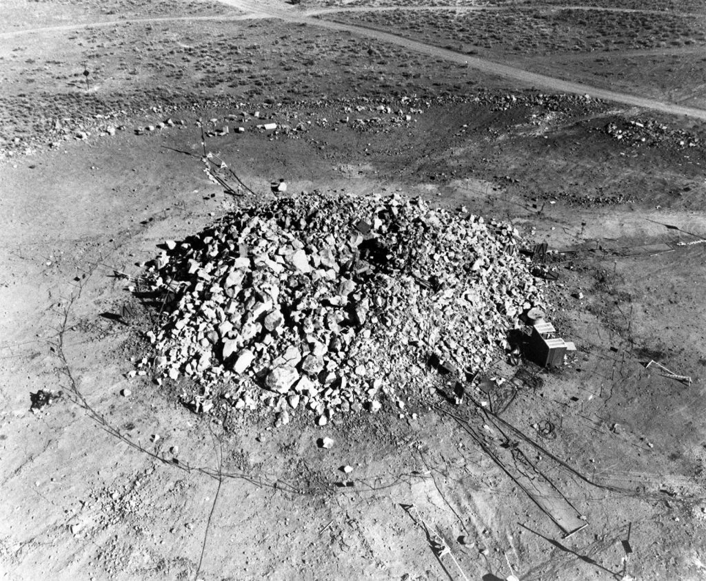 Large mound of broken rock, known as a "retarc," created by the Sulky underground nuclear test on December 18, 1964, as part of Operation Whetstone and Project Plowshare, Nevada Test Site. 